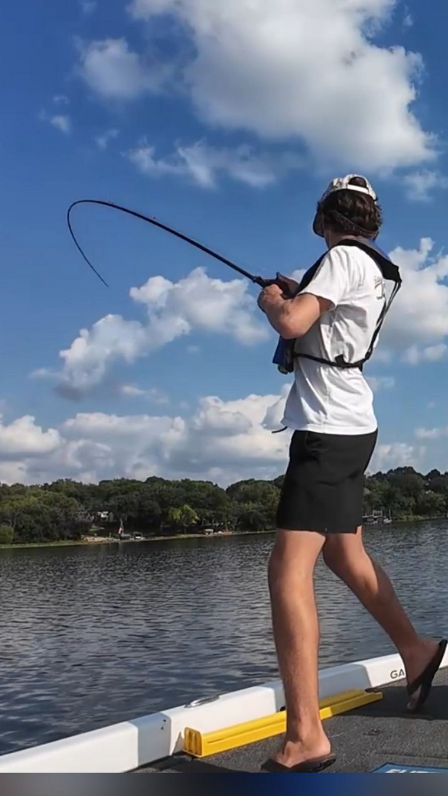 A student angler working a fish from the boat